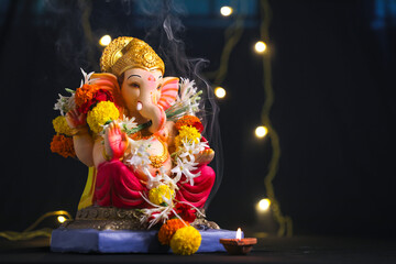 Decorative Lord ganesha sclupture on dark background.