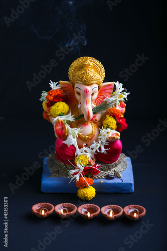 Decorative Lord ganesha sclupture on dark background.