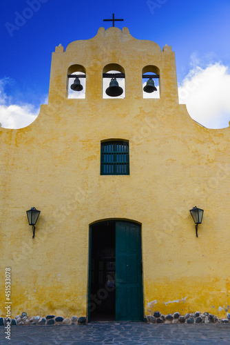 The simple yellow facade of the Iglesia San José de Cachi church at dusk on the small and historic town of Cachi, Valles Calchaquíes, Salta province, northwest Argentina photo