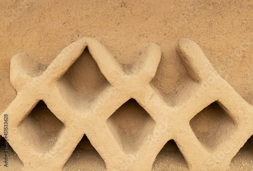 Adobe decorations on a wall in Chan Chan adobe city, Trujillo, Peru. photo