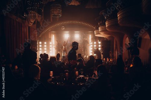 Silhouettes of a crowd on show in night club celebration. © primipil