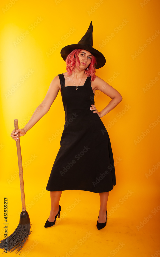 Portrait of her she nice-looking attractive pretty charming lovely slender cheerful cheery lady wizard holding in hand broom festal event isolated bright vivid shine vibrant yellow color background Portrait of her she nice-looking attractive pretty charming lovely slender cheerful cheery lady wizard holding in hand broom festal event isolated bright vivid shine vibrant yellow color background