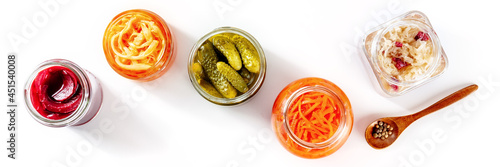 Fermented food panorama on a white background. Canned vegetables. Pickles, sauerkraut and other organic preserves in glass jars. Healthy vegan cooking concept