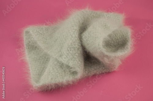 winter knitted scarf front on pink background.