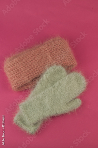 women's winter down mittens on pink background