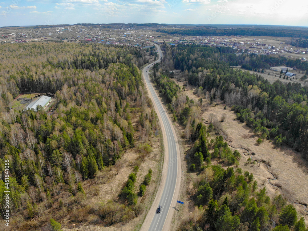 Aerial view of the road between forests in spring (Kirov, Russia)