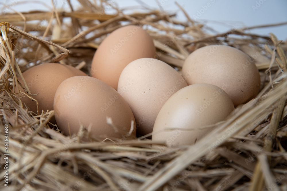 easter basket with easter eggs on straw background easter basket with easter eggs on straw background