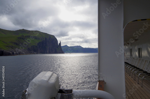 Expedition cruising on luxury cruiseship cruise ship liner to Nordic adventure Polar Circle Faroe Islands with breathtaking nature landscape scenery cliffs coast line photo