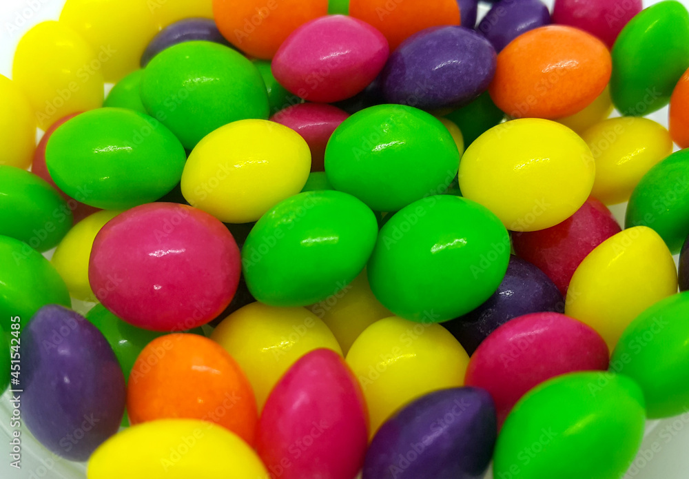Bright candies in multicolored glaze, close up background Bright candies in multicolored glaze, close up background