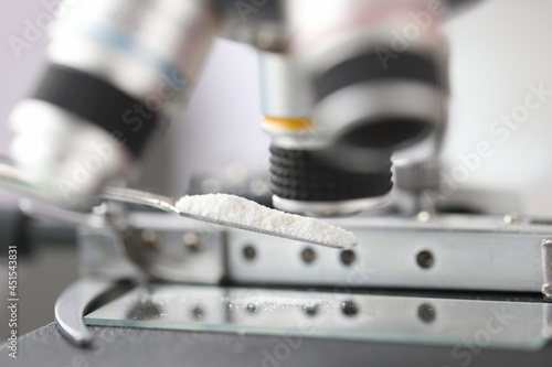 Study of white powder in a laboratory under microscope closeup photo