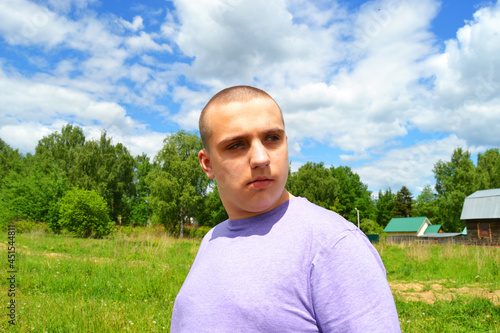 An autistic boy walks in nature in the village. Privacy, tranquility
