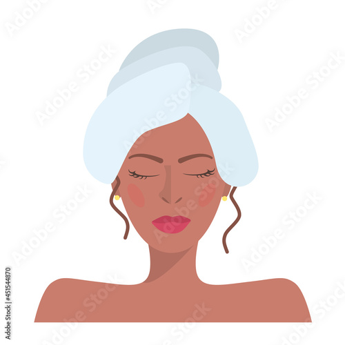 Close-up of a tanned brunette girl with curly hair, wet hair wrapped in a towel and closed eyes isolated