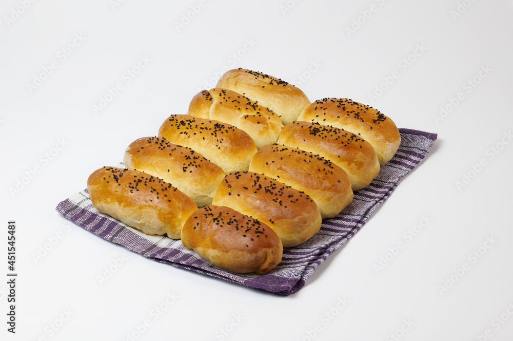 baked, pie goods with black sesame grains on a white background