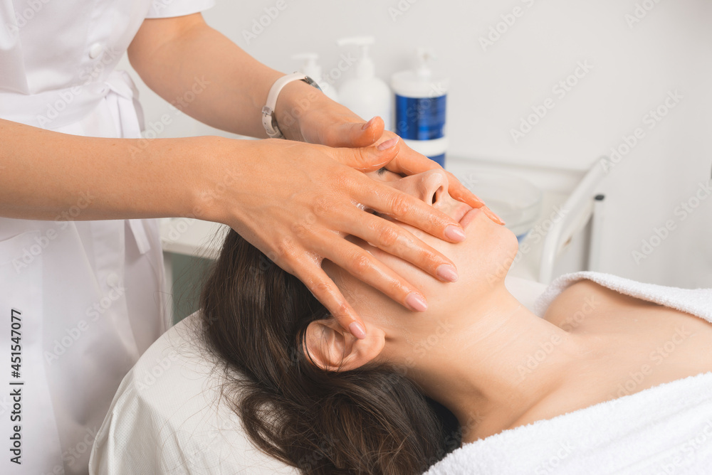 Fototapeta premium Close up photo of young woman having facial massage in beauty salon