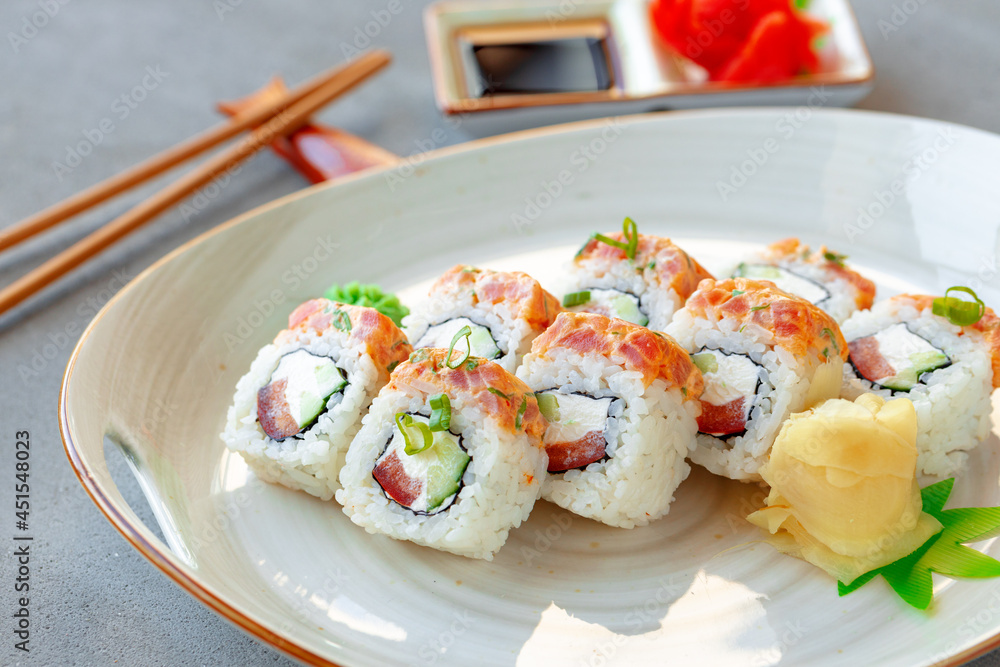 Japanese sushi roll with salmon on plate Japanese sushi roll with salmon on plate