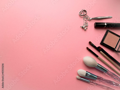Fototapeta Naklejka Na Ścianę i Meble -  Brushes a flat lay with copy space. Beauty cosmetic makeup product layout. Stylish design. Creative fashionable concept. Cosmetics make-up brushes collection on a pink background, top view.
