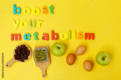 Boost your metabolism weight loss products a yellow background top view. photo