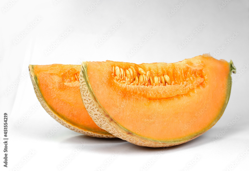 Ripe delicious melon and a piece of melon are isolated on a white background. Ripe delicious melon and a piece of melon are isolated on a white background.