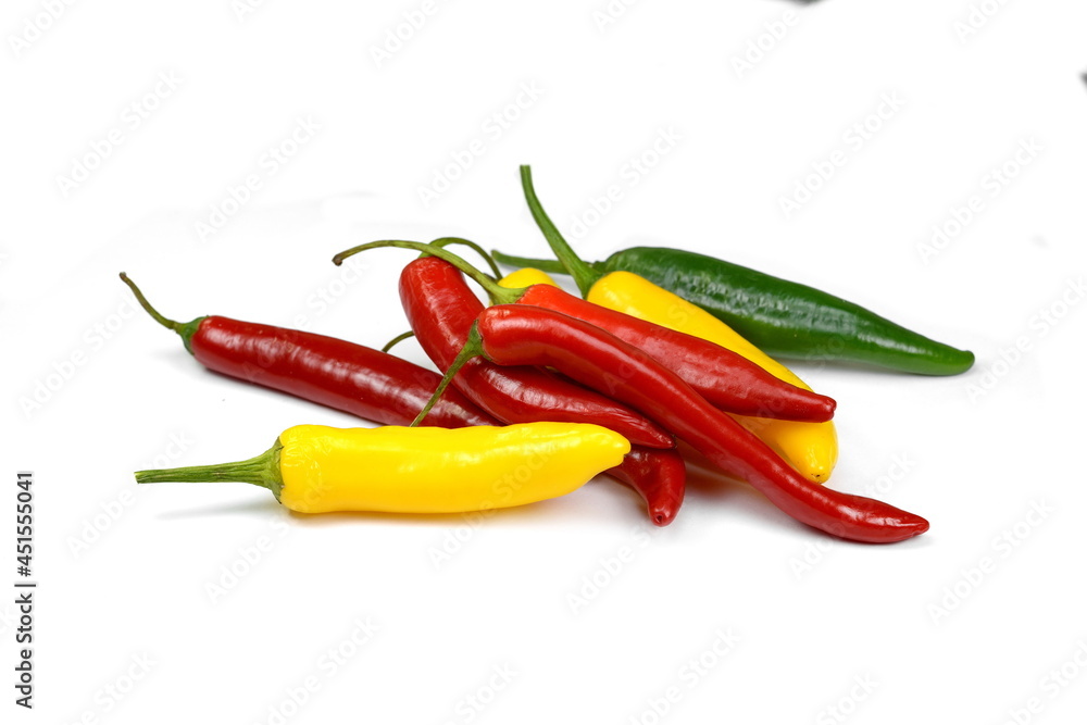 chiili peppers in different colors, yellow, green and red, isolated on white; also know as chilli peppers, chille peppers or just chilli