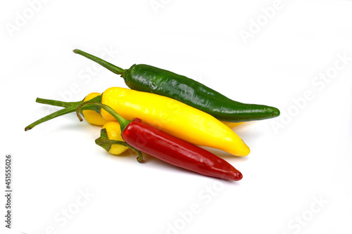 chiili peppers in different colors, yellow, green and red, isolated on white; also know as chilli peppers, chille peppers or just chilli photo