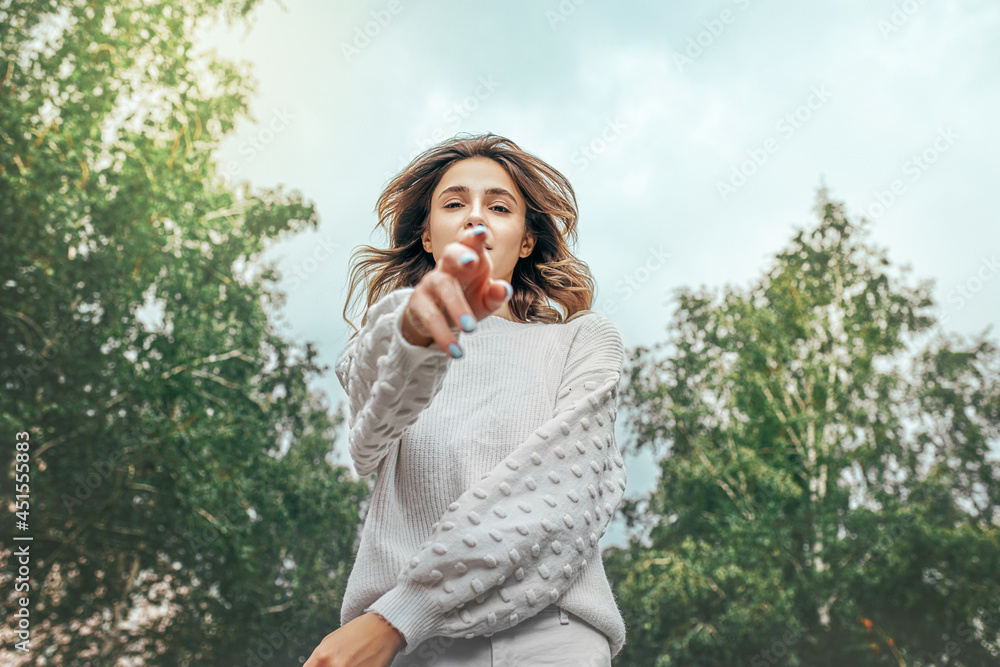 Beautiful young model girl in a white sweater walks in the park Beautiful young model girl in a white sweater walks in the park