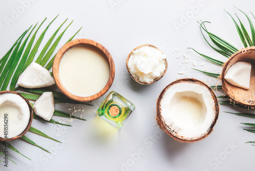 Natural Coconuts products - mct butter, oil, milk, shavings on gray background. Hair, skin and body treatment and healthy food. Top view