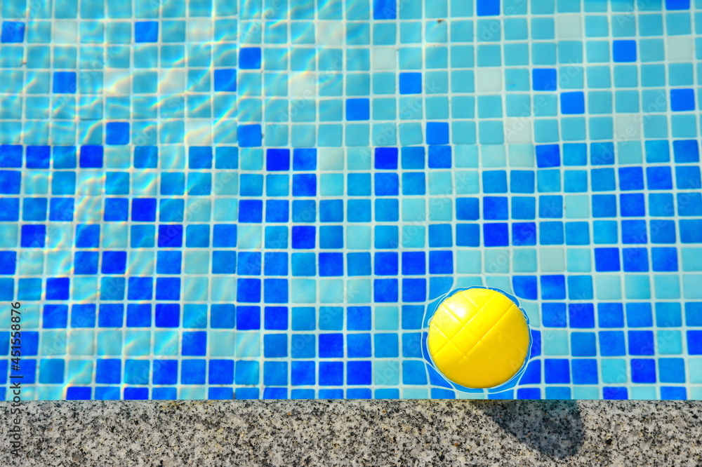 Surface of blue swimming pool with ball, background of water in swimming pool. Water background blue.