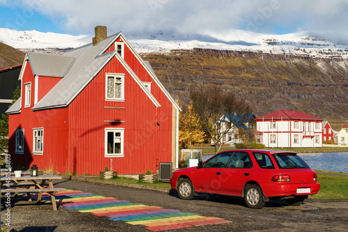 Unique vibrant colour of an Icelandic house beside the mountain range -- Seydisfjordur , Iceland photo