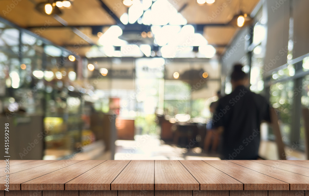 Empty wooden table top with lights bokeh on blur restaurant background. Empty wooden table top with lights bokeh on blur restaurant background.