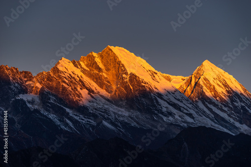 Red light over snow mountain peak in a morning sunrise, Himalaya mountains range in Everest region, Nepal
