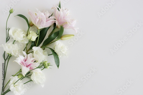 White and pink flowers frame on white background top view  copy space. Flowers template.Floral card.