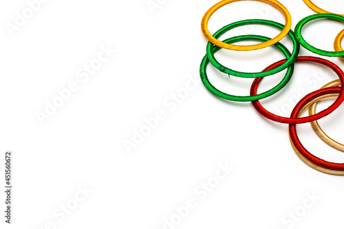Colorful scattered bangles on abstract white background with copy space