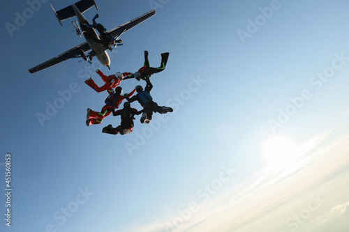 Skydiving. A team of skydivers is in the sky.