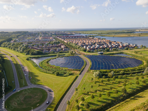 Modern innovative residential area in Almere, along the waterside, including solar panel field. The Netherlands, Flevoland.