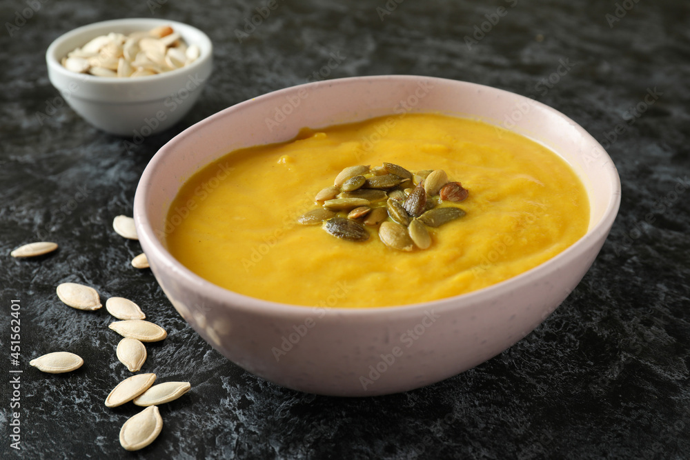 Concept of tasty food with pumpkin soup on black smokey table Concept of tasty food with pumpkin soup on black smokey table