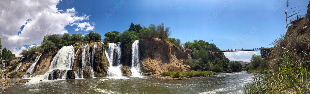 muradiye waterfall, van province turkey. open air view of trees and exuberant waterfall.