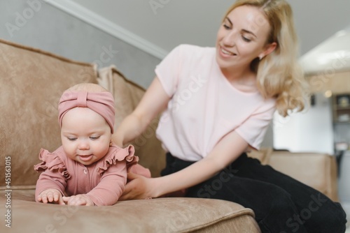 Portrait of young mother with cute baby at home