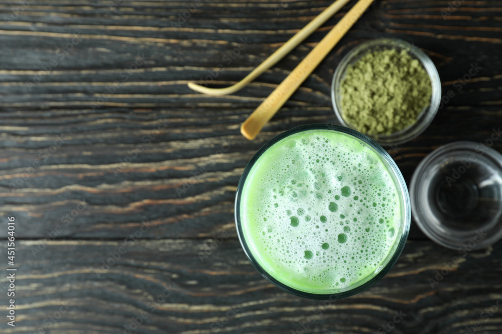 Matcha latte and accessories for making on wooden background Matcha latte and accessories for making on wooden background