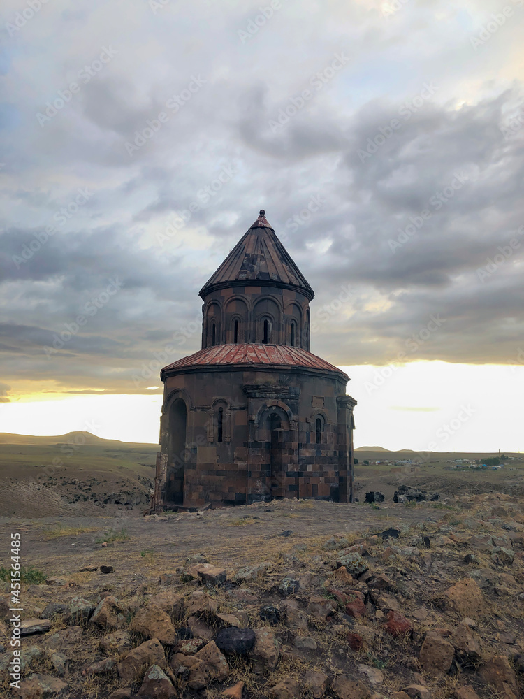 Ani ruins, Kars province, mountains and cloudy sky photo taken at sunset.
