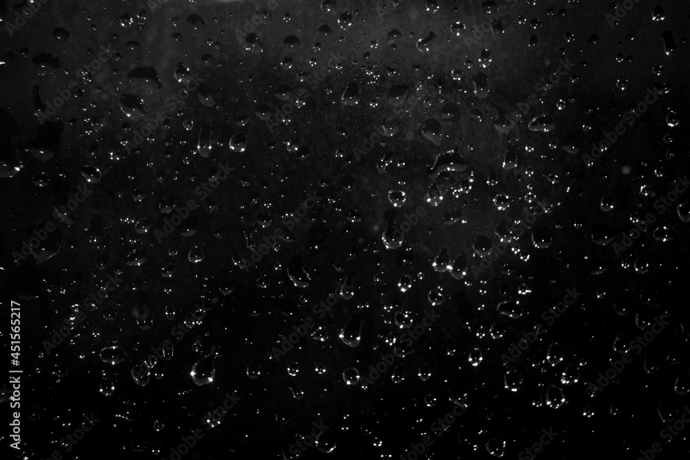drops of water on a dark glass. Abstract background