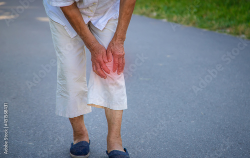 The grandmother has an old woman knee pain. Selective focus. photo