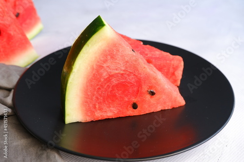 A slice of watermelon on a light blurred background. Berry. The fruit.