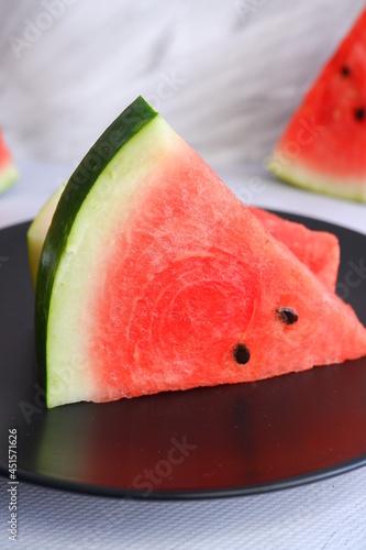 A slice of watermelon on a light blurred background. Berry. The fruit.