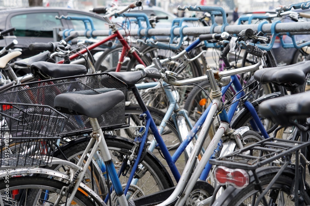 Bicycles parked on a busy street with cars in Lucerne, Switzerland. Background picture to mobility or alternative transport in cities. 
