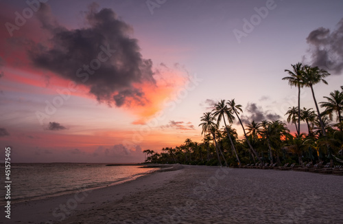 Palm trees on tropical coast at sunset. Crossroads Maldives, saii lagoon, june 2021.