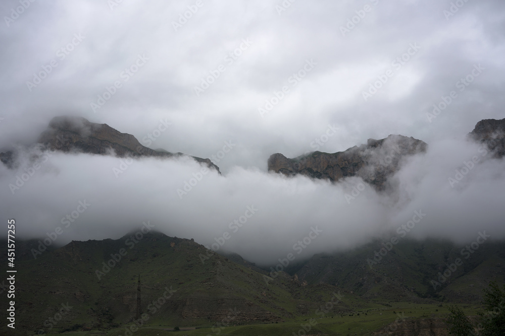 Caucasus mountains surrounded with clouds