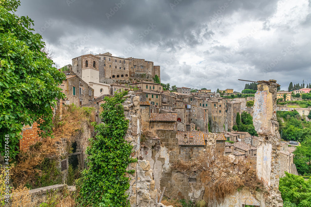 picturesque view of Sorano with old staircase, alley, underpass and plants in the Tuscan medieval village