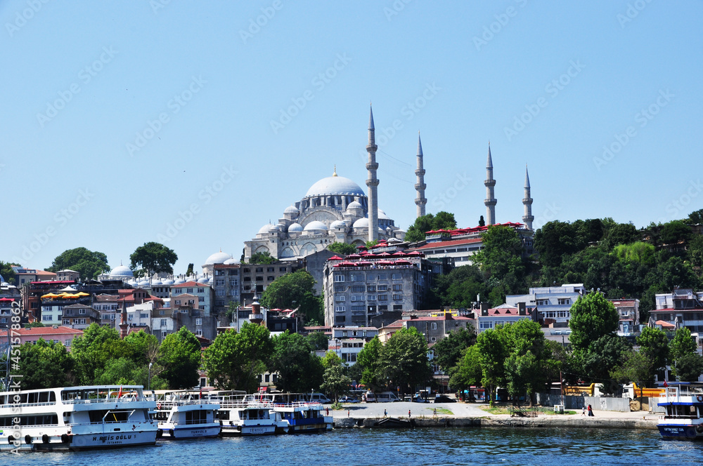 Panoramic view of Istanbul. Panorama of the Golden Horn Bay and the coastline with ships, residential buildings and the Suleymaniye Mosque. July 09, 2021, Istanbul, Turkey.