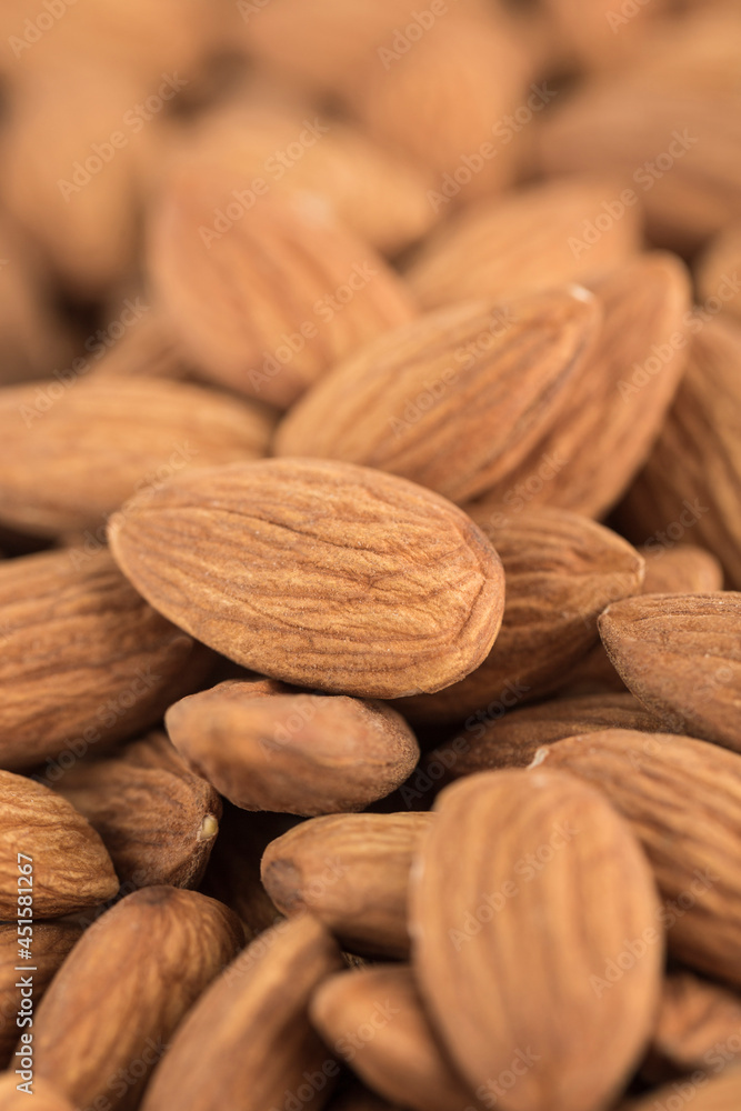 Dried almonds in bulk, close-up on the grain. Dried almonds in bulk, close-up on the grain.