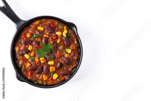 Traditional mexican tex mex chili con carne in iron pan isolated on white background. Top view. Copy space 